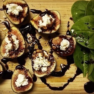 Fresh figs topped with goat cheese and balsamic vinegar with baby spinach 