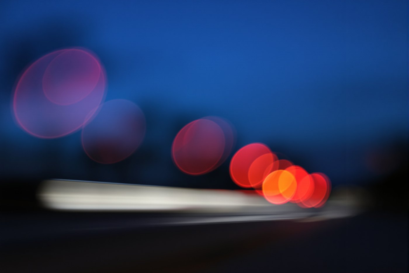 Soft out of focus traffic lights on a Florida road at dusk