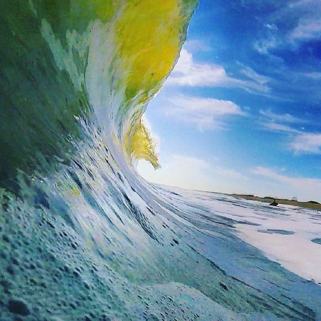 Sun Breaching Through A Perfect Wave