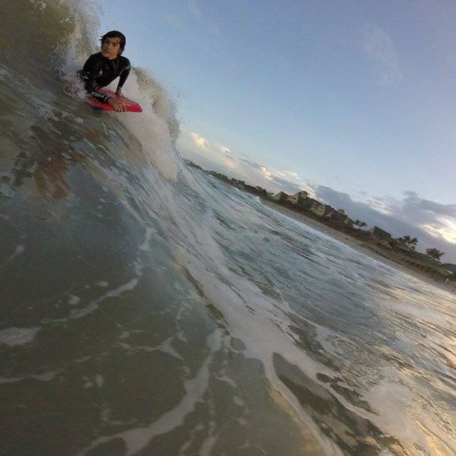 Youngling Rideing A Wave Beautiful Sunset
