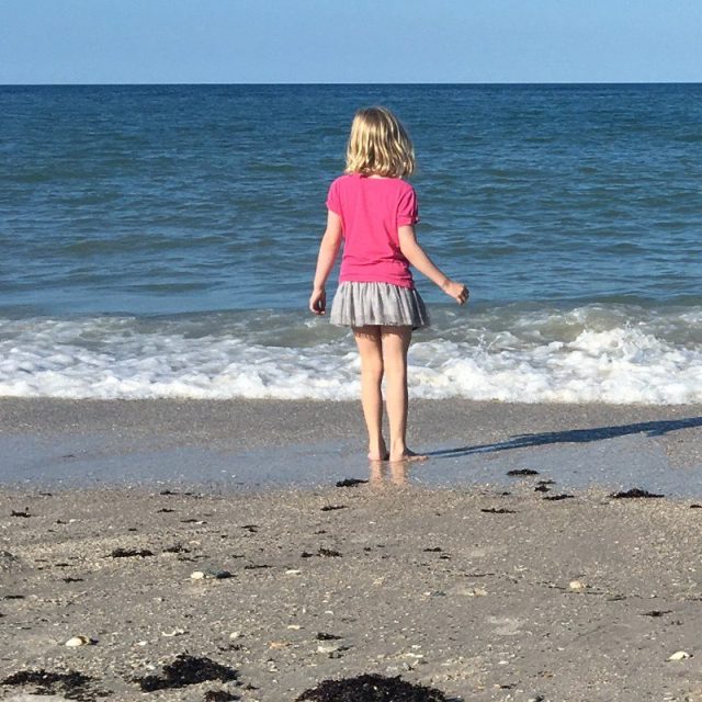 Seashell In Her Pocket And Sand Between Her Toes