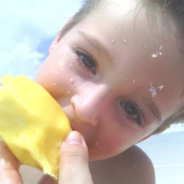 Sun, Sand, & A Mango In Hand