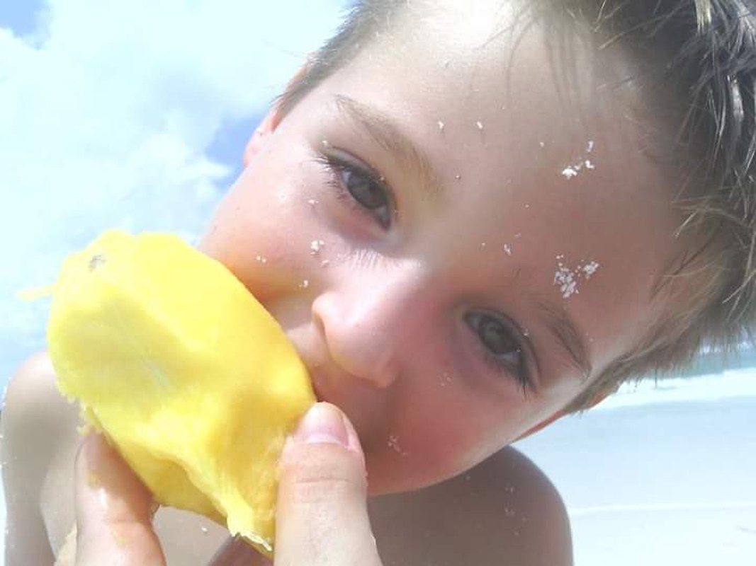 Sun, Sand, & A Mango In Hand
