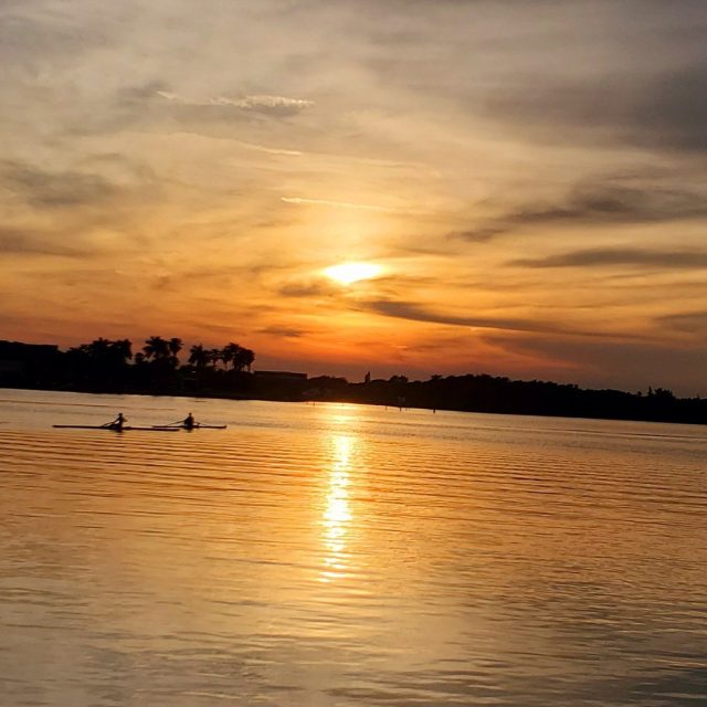 Sunset Rowing Past Riverside Cafe