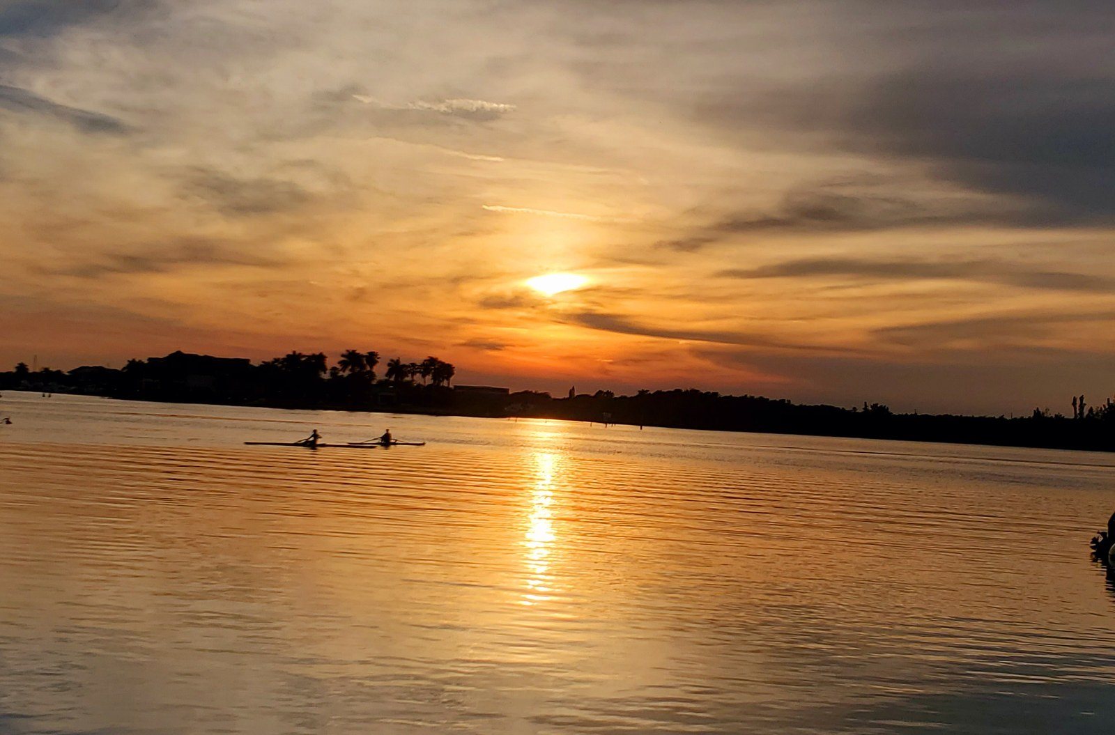 Sunset Rowing Past Riverside Cafe